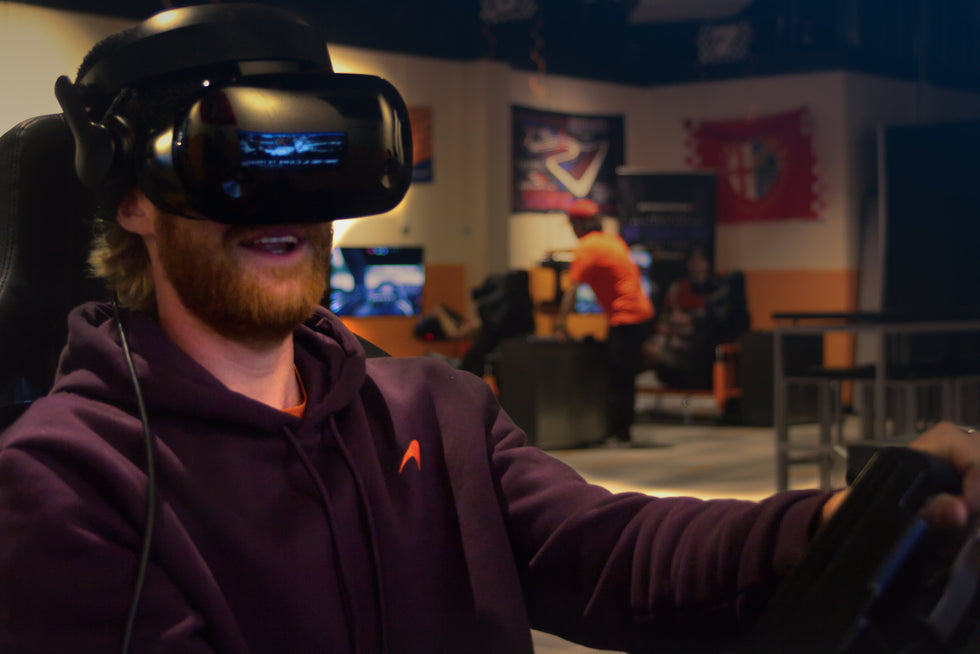 Person with VR goggles on racing at TracksVR
