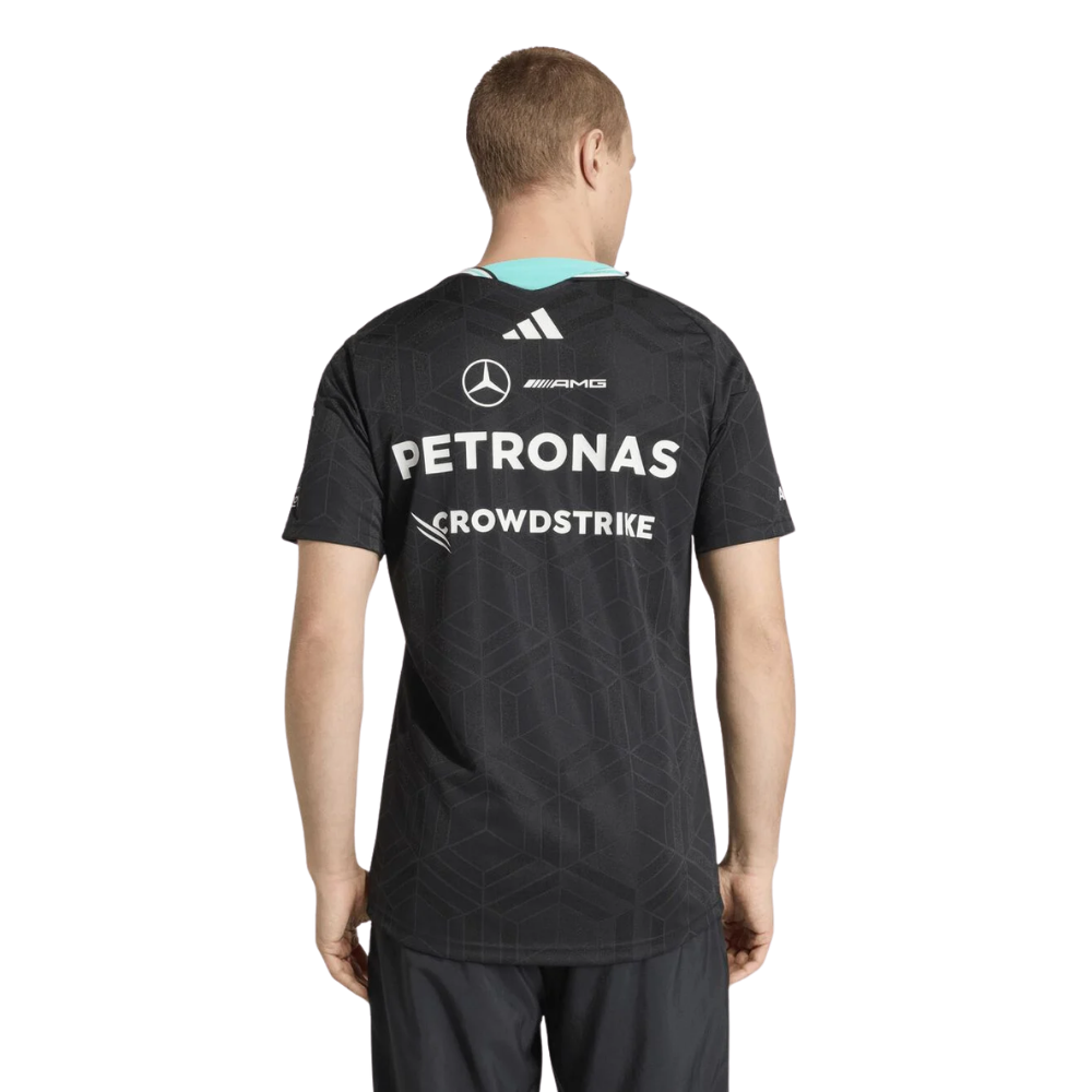 Person wearing a black sports jersey with sponsor logos on a white background